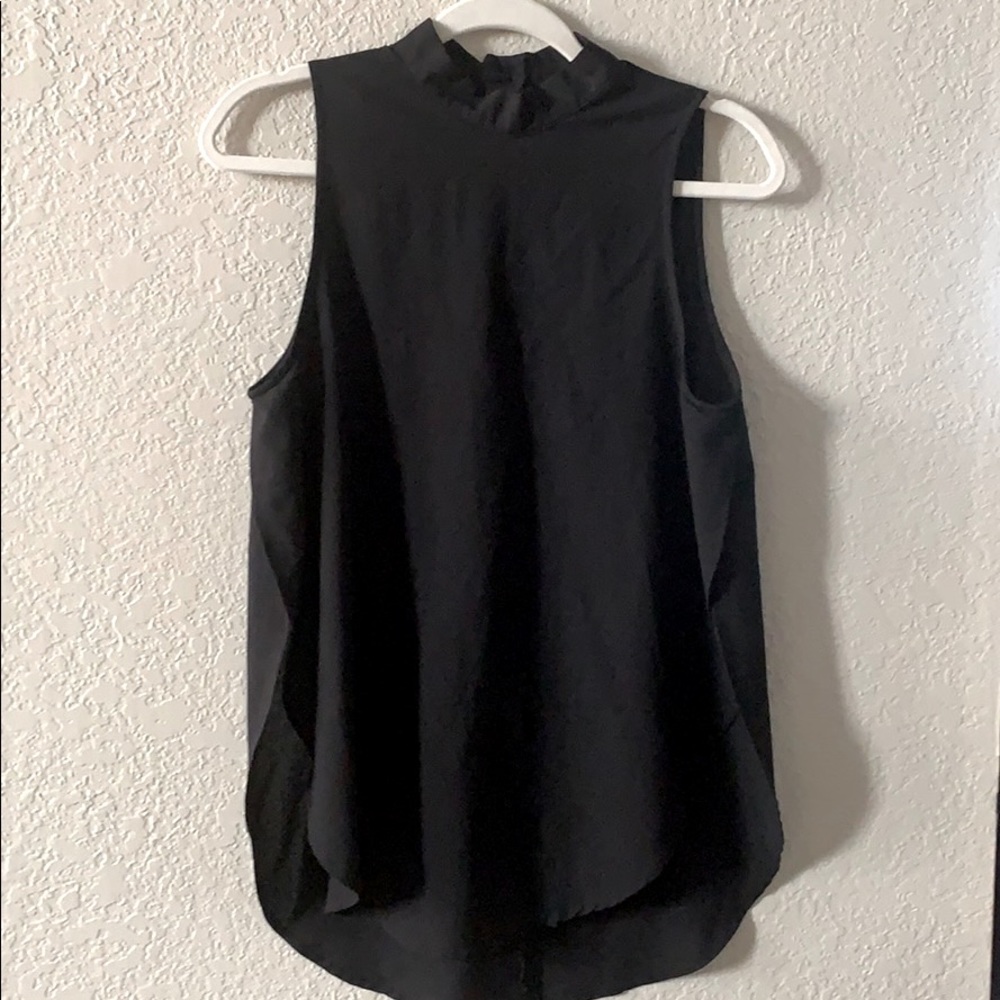 Black sleeveless, mock neck blouse.